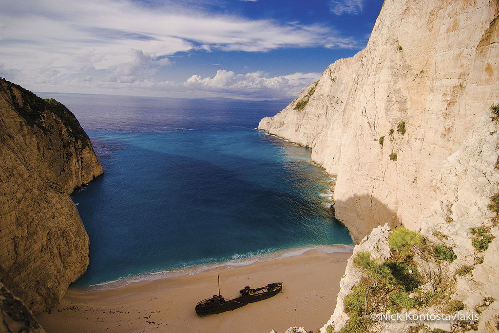Shipwreck. It is one of the most famous beaches on the planet and it is the tourist trademark of Zakynthos and Greece. This unique setting was created in 1982, when the ship “Panagiotis”, carrying illegal cigarettes from Turkey, ran aground due to adverse weather conditions and engine failure. The famous beach is only accessible by boat, although you can admire the view from above on a specially built platform near the village of Maries. (© Nick Kontostavlakis)